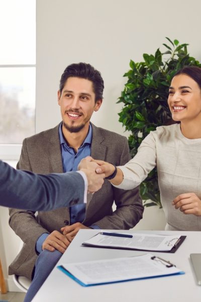 Portrait,Of,A,Happy,Couple,Shaking,Hands,With,A,Male